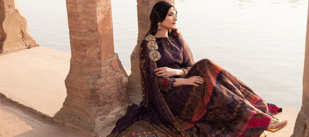 A women sitting by the water wearing elegant Abeer dress from Soraya collection by Farah. K