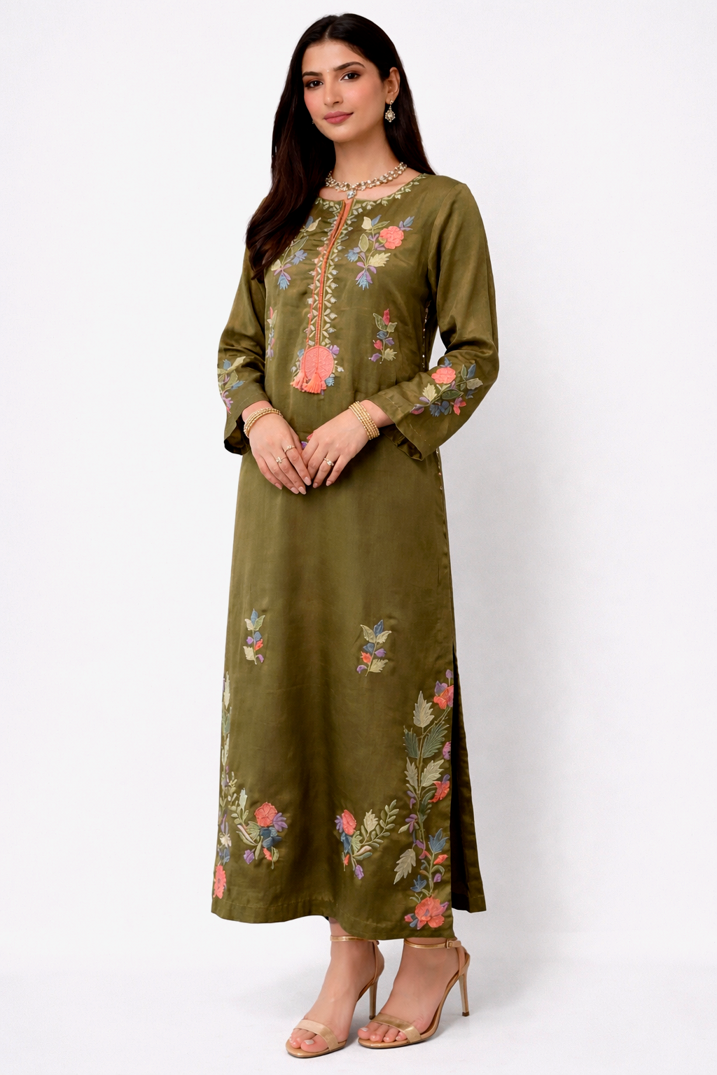 Close-up of Olive Enigma dress in raw silk with multi-color floral appliqué and embroidery, handcrafted in Pakistan for Eid 2026.