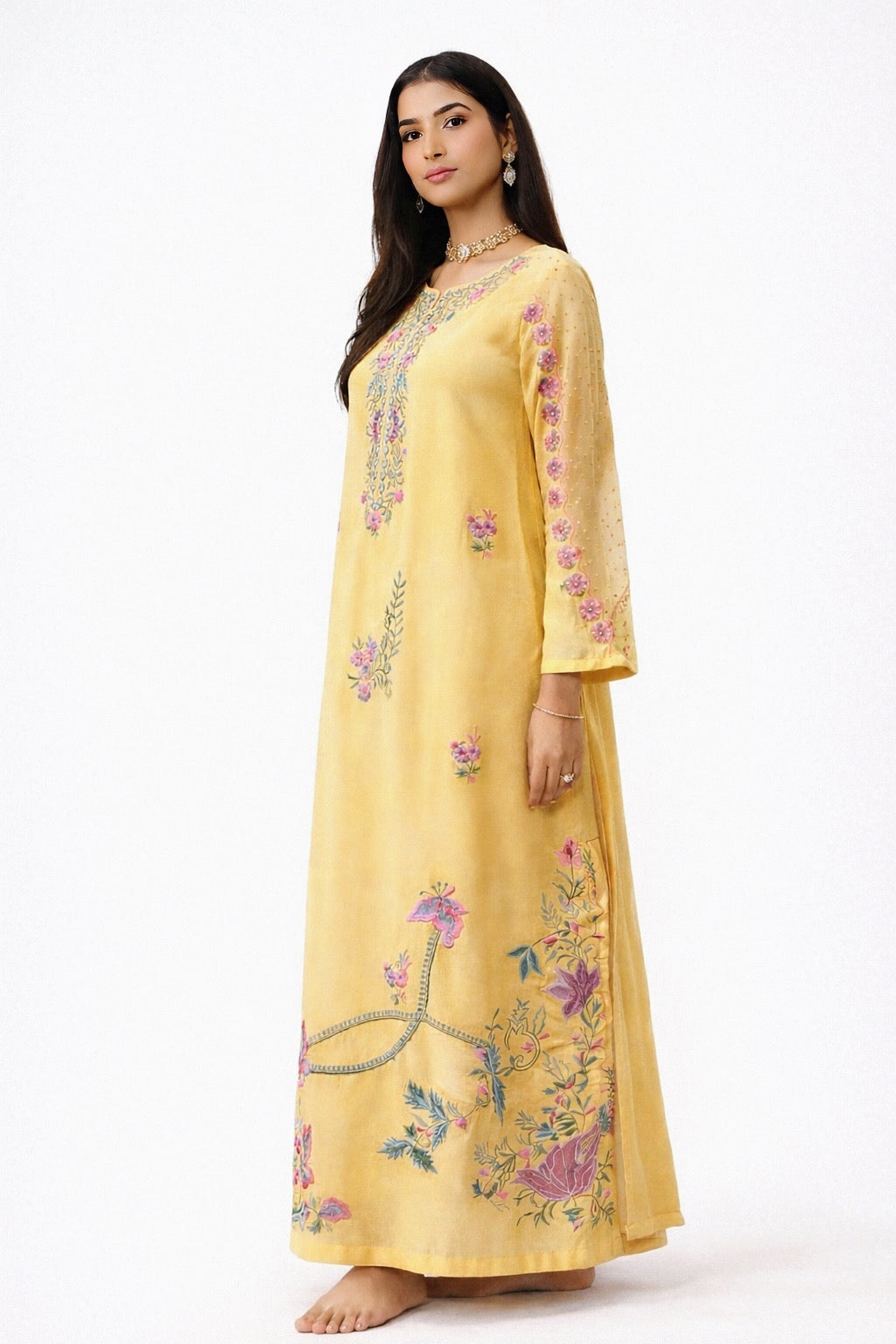 Woman wearing a yellow embroidered kaftan kurta  dress on a white background