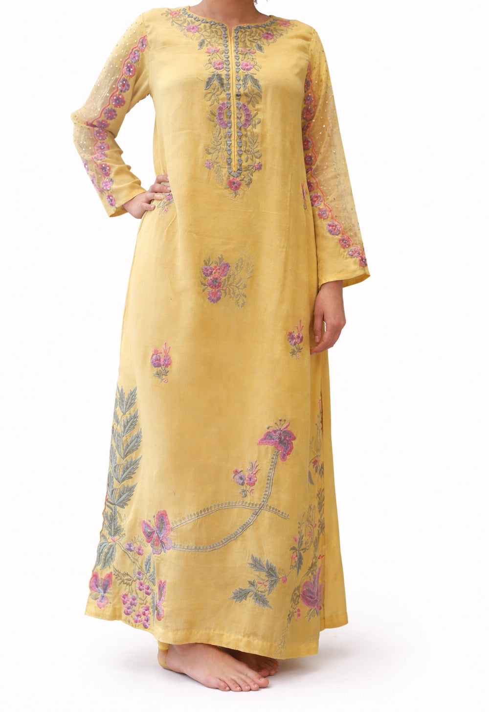 Yellow embroidered dress on a white background