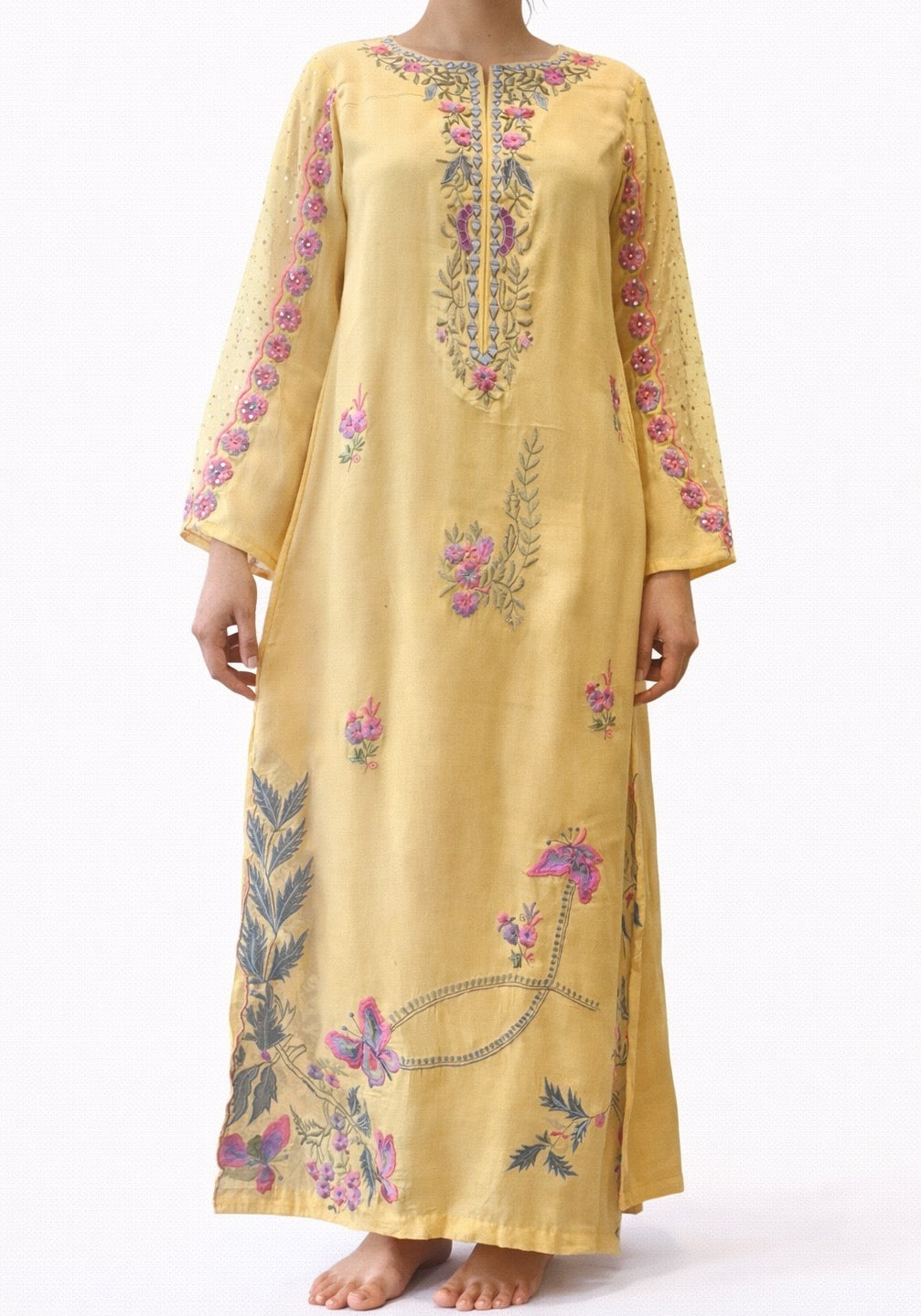 Yellow embroidered dress with floral patterns on a white background