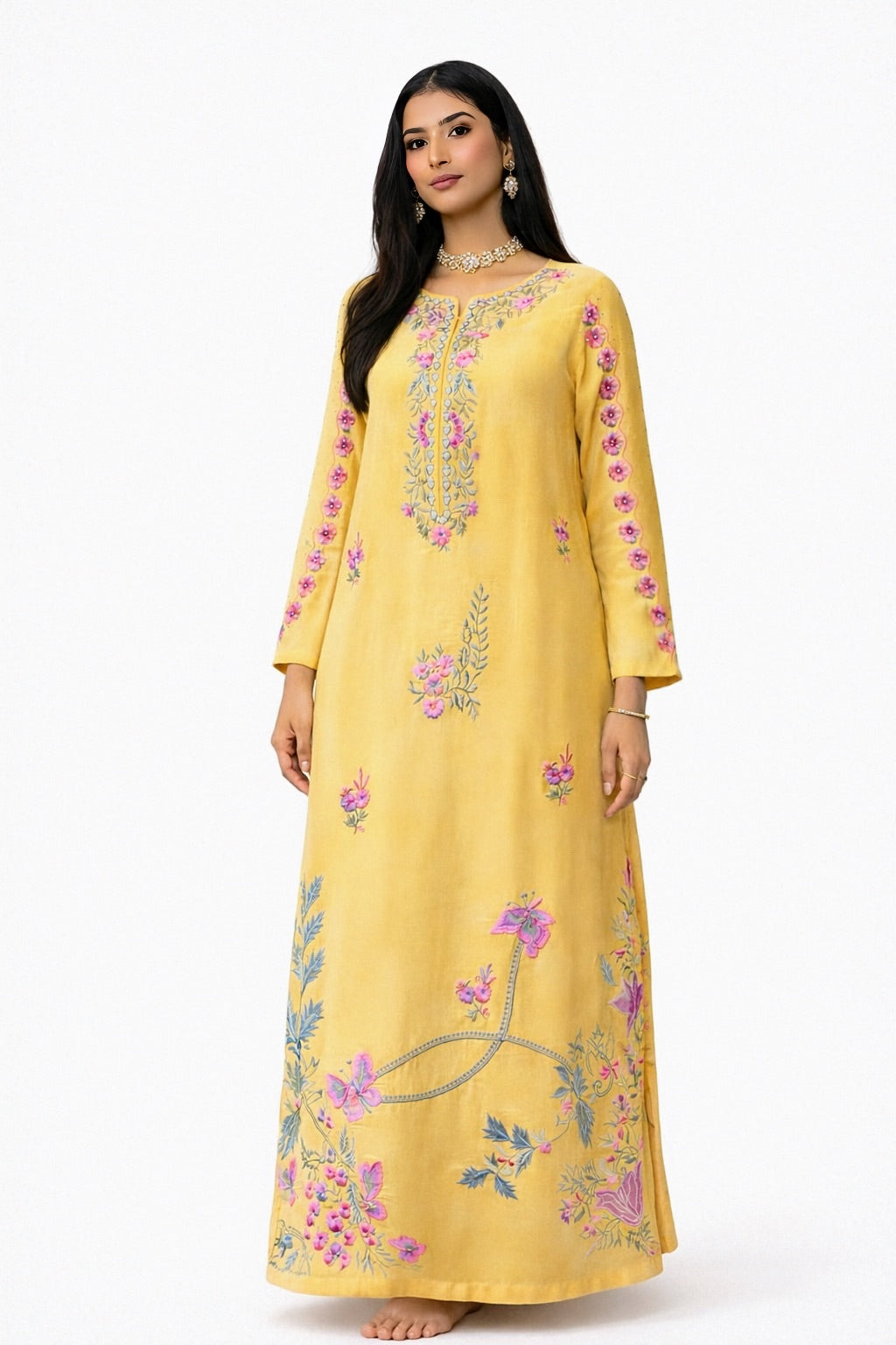 Woman wearing a yellow embroidered kaftan kurta style  dress on a white background