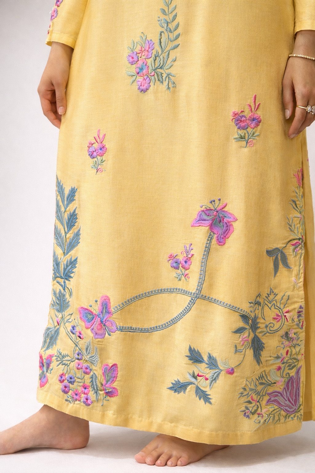 Woman wearing Yellow embroidered kurta kaftan style punjabi Pakistani formal dress 