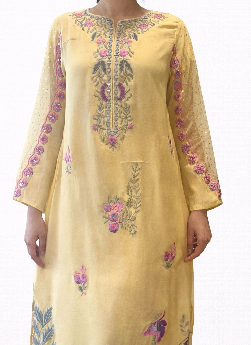 Yellow embroidered dress with floral patterns on a white background