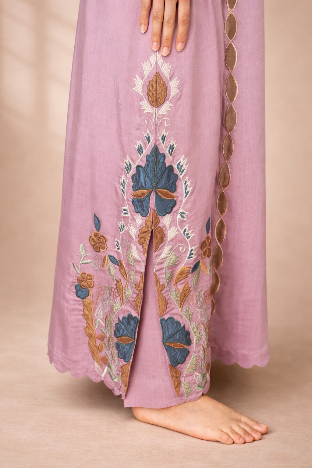 Lavandar embroidered side slit design  on a beige background