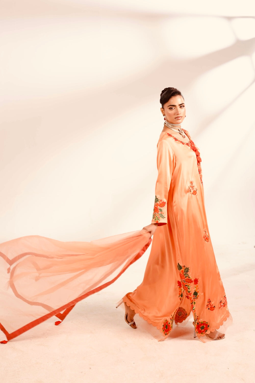 Woman in Pakistani Long dress in peach colour and flowy dupatta 
